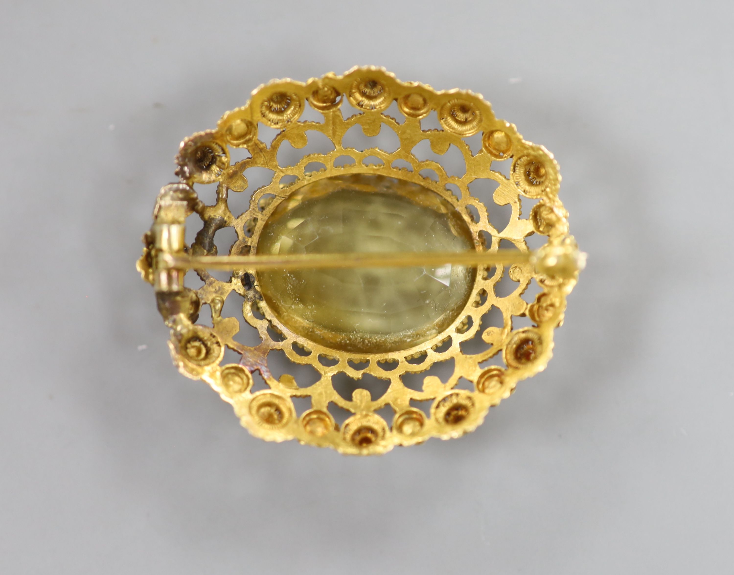 A late Victorian yellow metal and citrine set oval brooch, with canetile work decoration